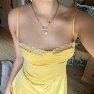 Yellow slip dress with open back and lace detailing